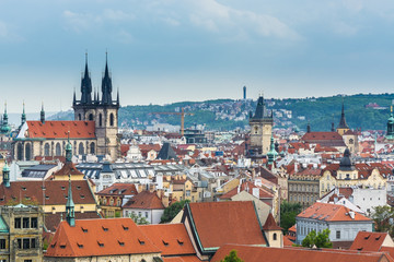Aerial view of citycape of old town of Prague, with a lot of red rooftops and  The Church of Mother of God before Týn, and the power tower.