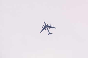 Huge transport turbine planes high in the blue sky.