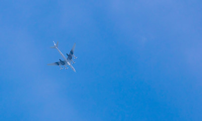 Huge transport turbine planes high in the blue sky.