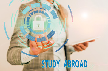 Word writing text Study Abroad. Business photo showcasing live in a foreign country and attend a foreign university Female human wear formal work suit presenting presentation use smart device