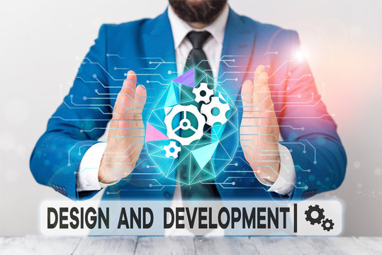 Text sign showing Design And Development. Business photo showcasing Defining the Specification of Products and Services Male human wear formal work suit presenting presentation using smart device