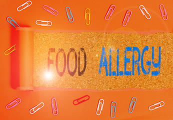 Writing note showing Food Allergy. Business concept for an abnormal immune response after eating a...
