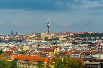 Fototapeta na wymiar Aerial view of citycape of old town of Prague, with a lot of rooftops, churches, and the landmark of Television Tower. view from the Letna park.