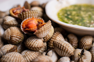 Scalding clams are appetizing red with a spicy sauce.