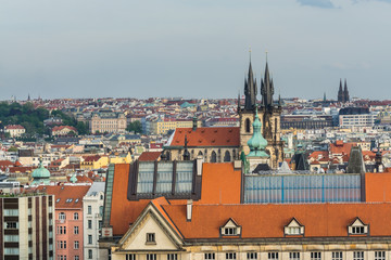 Fototapeta na wymiar Aerial view of citycape of old town of Prague, with a lot of red rooftops and The Church of Mother of God before Týn. A gothic church and a dominant feature of the Old Town. View from the Letna park.
