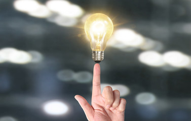 Hand of holding illuminated light bulb, innovation inspiration concept