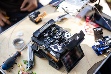 Fiber optic cable repair. A special device for connecting wires through which the Internet goes....
