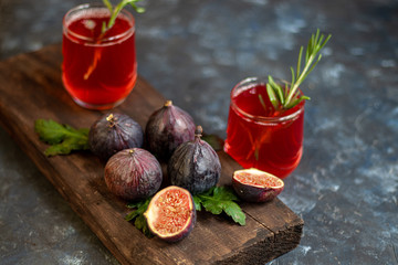 Ripe, beautiful, purple figs.  Sweet and juicy.  Mediterranean fruit is very healthy.  You can jerk and cook jam.  There is empty space on a dark copyspace background.  Food for vegetarians.