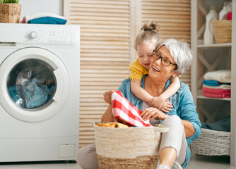 grandma and child are doing laundry