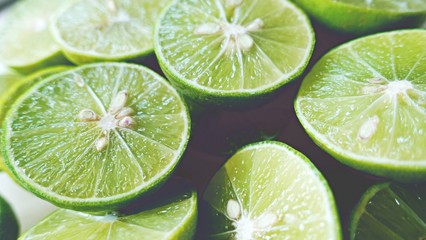 Lime Background. Close up shot of limes. Selective Focus of sliced lime.