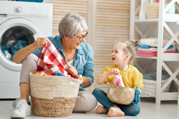 grandma and child are doing laundry