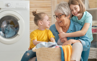grandma and children are doing laundry