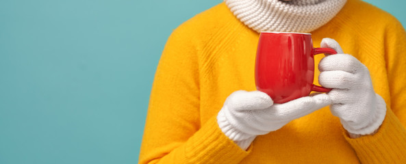 woman holding a cup of warm drink