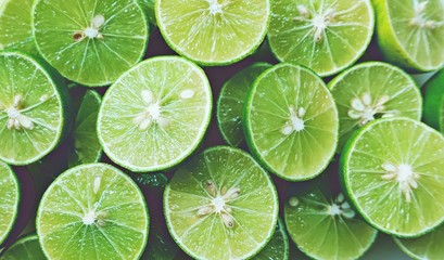 Lime Background. Close up shot of limes. Selective Focus of sliced lime.