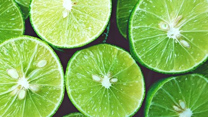 Lime Background. Close up shot of limes. Selective Focus of sliced lime.