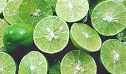 Lime Background. Close up shot of limes. Selective Focus of sliced lime.