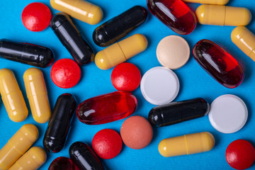 Top view with pills of many colors and shapes