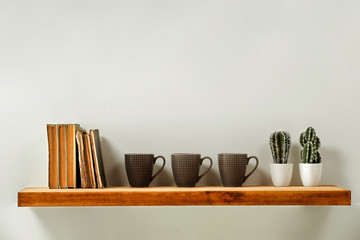 Wooden kitchen shelf of free space for your decoration and gray wall space 