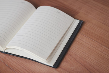 Open notebook on the old wooden floor.
