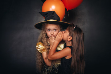 Funny girls with balloons sharing secret