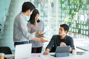 Young business team discussing together in conference room during meeting at office. Teamwork and...