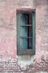 Fototapeta na wymiar Stock image of an old window on exposed brick wall.
