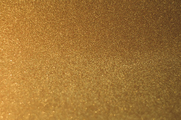 Fototapeta na wymiar Defocused lights blurred abstract gold color background