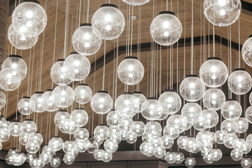 Lamps hanging from the ceiling on the wooden background