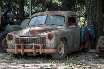 Stock image of an old, rusted, abandoned car.