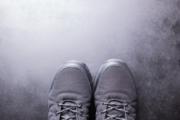 Black men's sneakers close-up on a black isolated background.