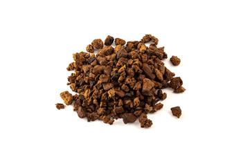 a pile of natural and wild chaga mushroom pieces on white background
