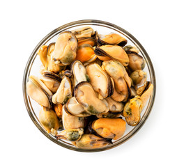 Peeled mussels in a glass dish on a white. The view of the top.