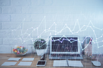 Double exposure of chart and financial info and work space with computer background. Concept of international online trading.