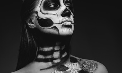 Young female with spooky skeleton makeup