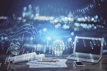 Stock market graph on background with desk and personal computer. Multi exposure. Concept of financial analysis.