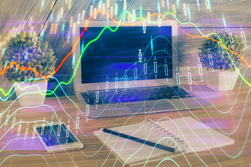 Double exposure of chart and financial info and work space with computer background. Concept of international online trading.