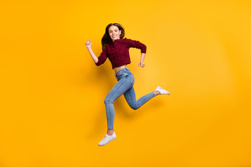 Fototapeta na wymiar Full size profile side photo of lovely youth running in maroon pullover isolated over yellow background