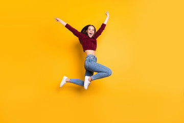 Fototapeta na wymiar Full length photo of charming cute girl raising her hands screaming wearing burgundy sweater isolated over yellow background