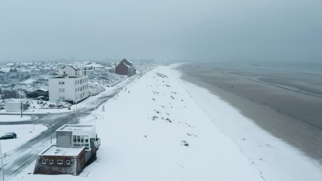 Seawall of Dunkirk in snow with some people (Dunkerque, France)