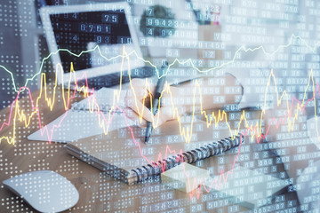 Financial charts displayed on woman's hand taking notes background. Concept of research. Double exposure