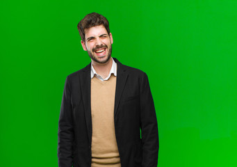 young businessman with cheerful, carefree, rebellious attitude, joking and sticking tongue out,...