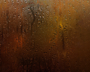 Fototapeta na wymiar Wet window with drops of water. Autumn mood and fall concept