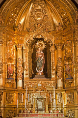 MADRID - MARCH 10: Madonna and baroque altar of Capilla del Sanctisimo from church San Isidoro on...