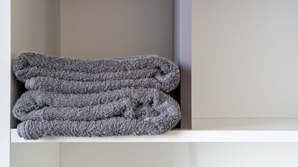 Close up of gray towel on a white rack.