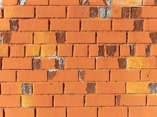 Background, bright orange brick wall. Weathered brickwork texture