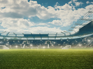 Soccer stadium with green grass, blue sky, tribunes and fans cheering