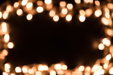 Blurry christmas lights. Christmas lights border. Christmas background with lights and free text space. Christmas lights on black background. New Year.