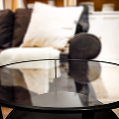 Glasses coffee table of free space for your decoration and blurred background of sitting room. 