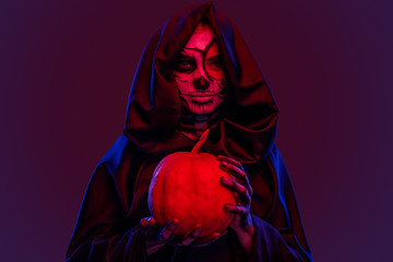 Creepy ghost with pumpkin under red light