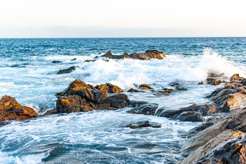foamy waves of the atlantic ocean beat against stones